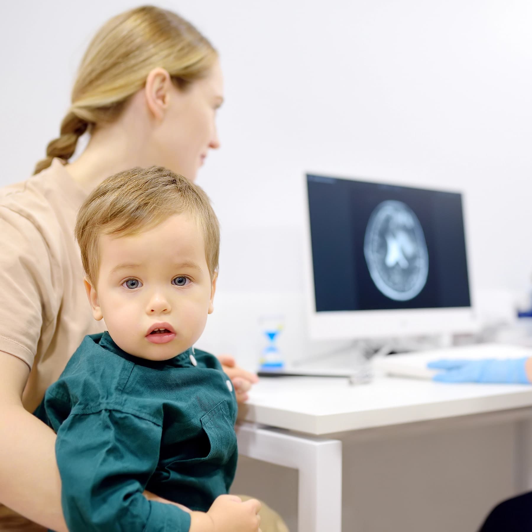 Infant having a medical check-up with a consultant